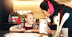 Mom, girl and cooking with flour at Christmas with smile, teaching and ingredients for cookies in home. People, mother and daughter in kitchen, learning or bonding with baking at xmas in family house