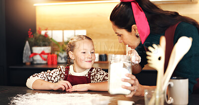 Buy stock photo Mom, girl and cooking with flour at Christmas with smile, teaching and ingredients for cookies in home. People, mother and daughter in kitchen, learning or bonding with baking at xmas in family house