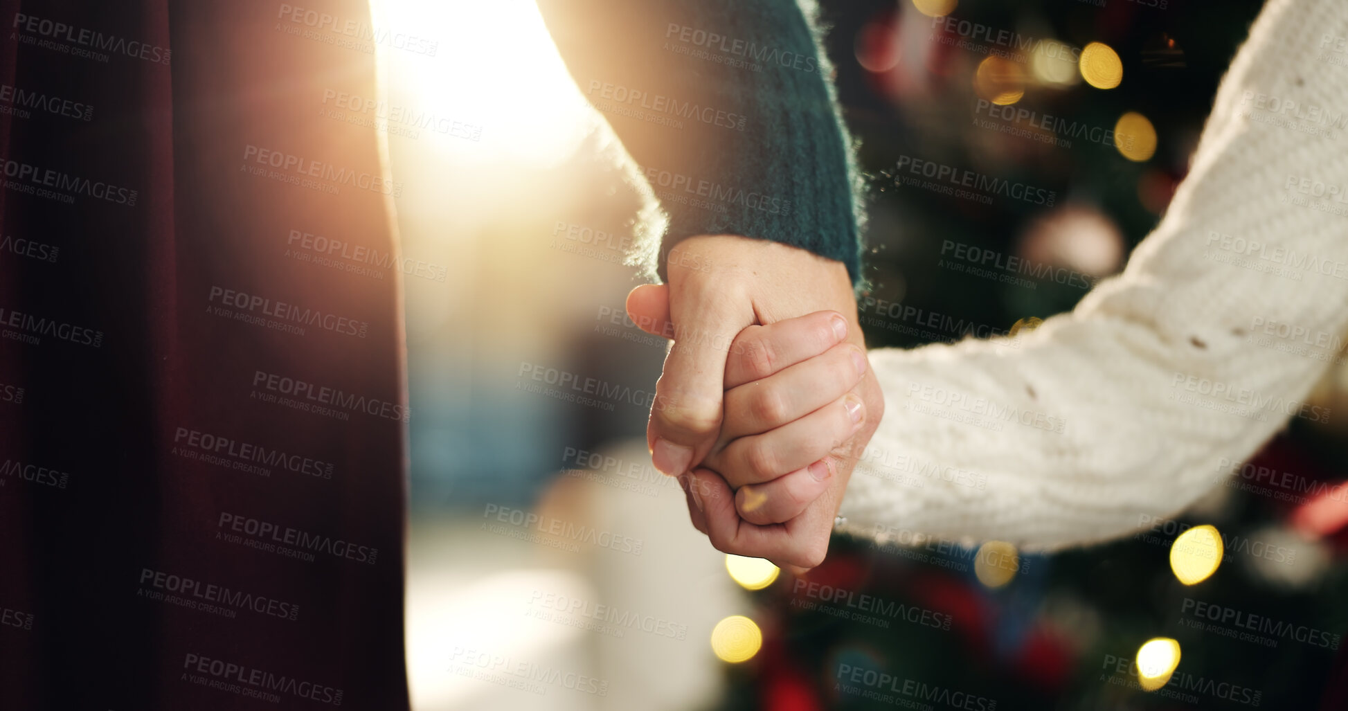 Buy stock photo Holding hands, parent and child in home with Christmas, support and love with bonding for holiday. Person, kid and care, connection and festive celebration at xmas tree with closeup at family house