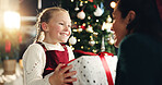 Girl, happy and mom with gift, Christmas tree and thanks with love, bonding or festive holiday. Child, mother and daughter with box, package or excited for present at xmas celebration at family house
