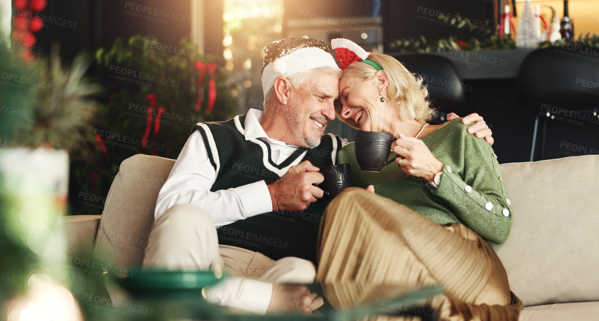 Buy stock photo Senior, happy couple or tea with hug for Christmas, love or romance in festive season in home. Smile, marriage support or elderly people bonding on sofa in lounge for holiday, care or coffee beverage