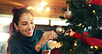 Smile, woman and tree with ornament on Christmas for celebration, decoration and festive season. Happy, female person and bauble trinket for preparation, sparkle aesthetic and xmas tradition at house