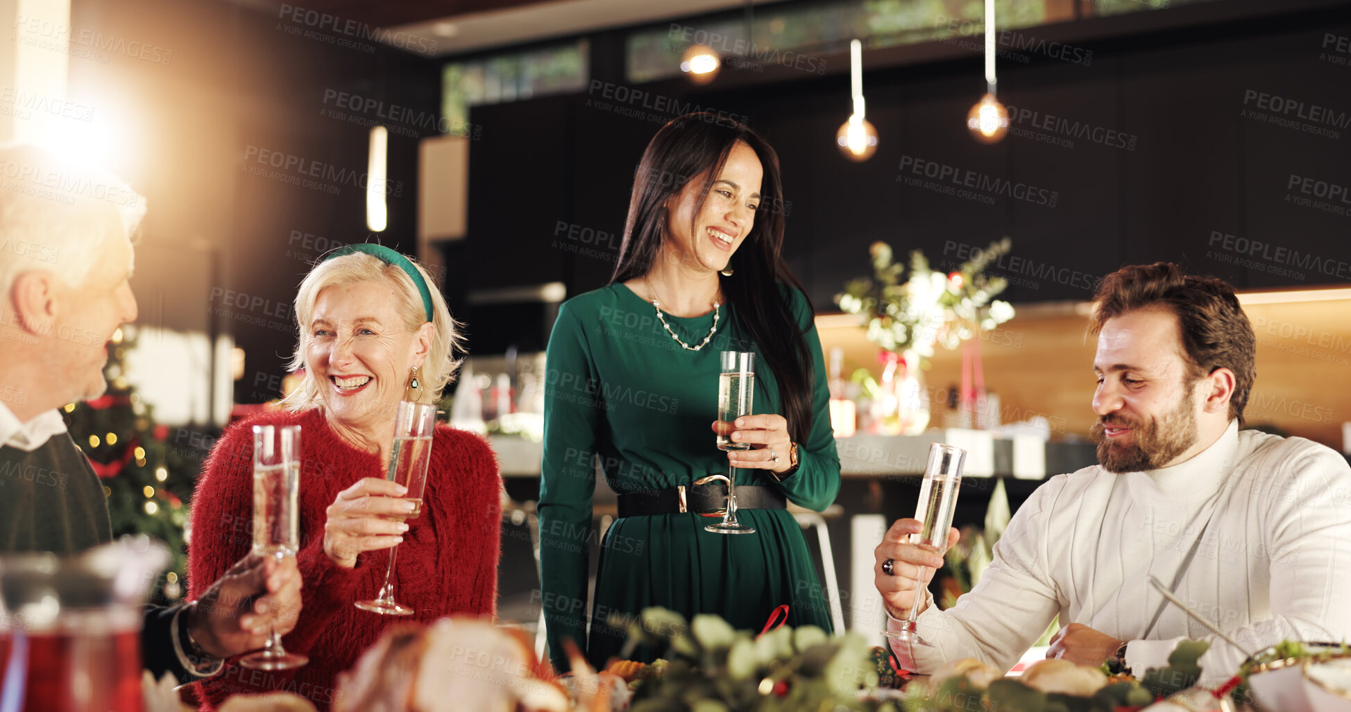 Buy stock photo Christmas dinner, champagne and family in home for celebration, happiness and bonding together. Smile, sparkling wine and people at xmas event for connection at festive season in house at night.