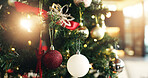 Christmas tree, bauble and light with decor for festive holiday, december or celebration in home. Closeup, object or decorations with ornaments hanging for christian tradition, santa or new year