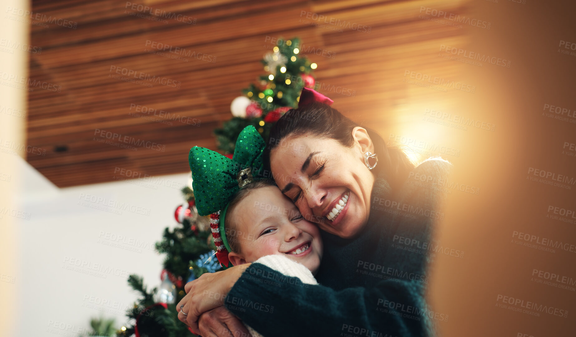 Buy stock photo Christmas, mother and happy girl with hug for festive season, bonding and family smile. Xmas portrait, daughter and mom with embrace in home for gift POV, love and holiday or child vacation memory