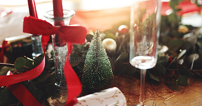 Buy stock photo Christmas, decorations and champagne glass on table in dining room for festive celebration, event or lunch. Holidays, place setting and tree for xmas with social gathering in December in home.