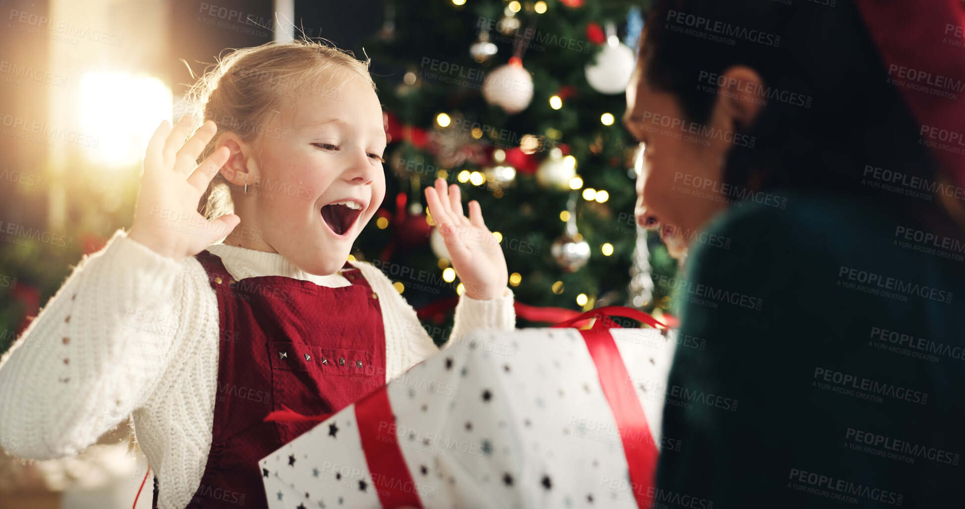 Buy stock photo Girl, mom and surprise with gift, Christmas tree and thanks with love, bonding or festive holiday. Child, mother and daughter with box, package or wow for present at xmas celebration in family house