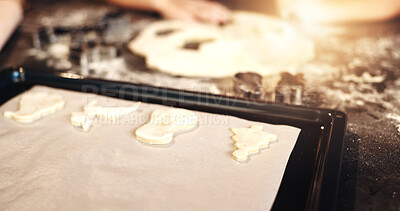 Buy stock photo Christmas cookies, baking paper and dessert for holiday celebration in home kitchen. Biscuit preparation, bake and food on oven tray for tasty meal, festive snack and hands of person cooking treats