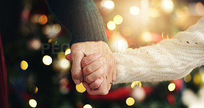 Buy stock photo Christmas, holding hands or mother with girl, home or bonding together with holiday season. Closeup, family or parent with mama, daughter or Xmas tree with tradition, bokeh or love with celebration