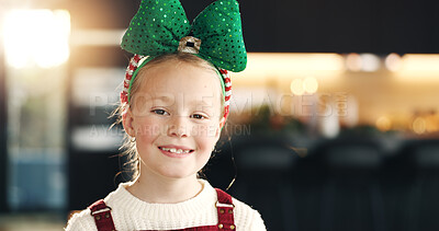 Buy stock photo Portrait, Christmas and girl with bow, kid and home with happiness, festive and tradition. Apartment, Xmas decoration and child in living room, holiday season and relax with break, vacation and smile
