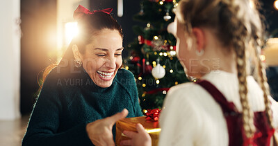 Buy stock photo Mom, happy and child with gift, Christmas tree and thanks with love, bonding and festive holiday. Woman, mother and daughter with box, package and excited for present at xmas party in family house