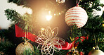 Christmas, tree and bauble with light for festive holiday, december or celebration in home. Closeup, object or decorations with ornaments hanging for christian tradition, santa or new year in house