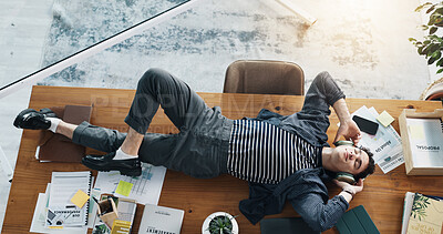 Buy stock photo Headphones, music or businessman on table to relax for break, radio entertainment or audio. Track, above or streaming podcast in office with calm employee lying on desk in workplace for rest or peace