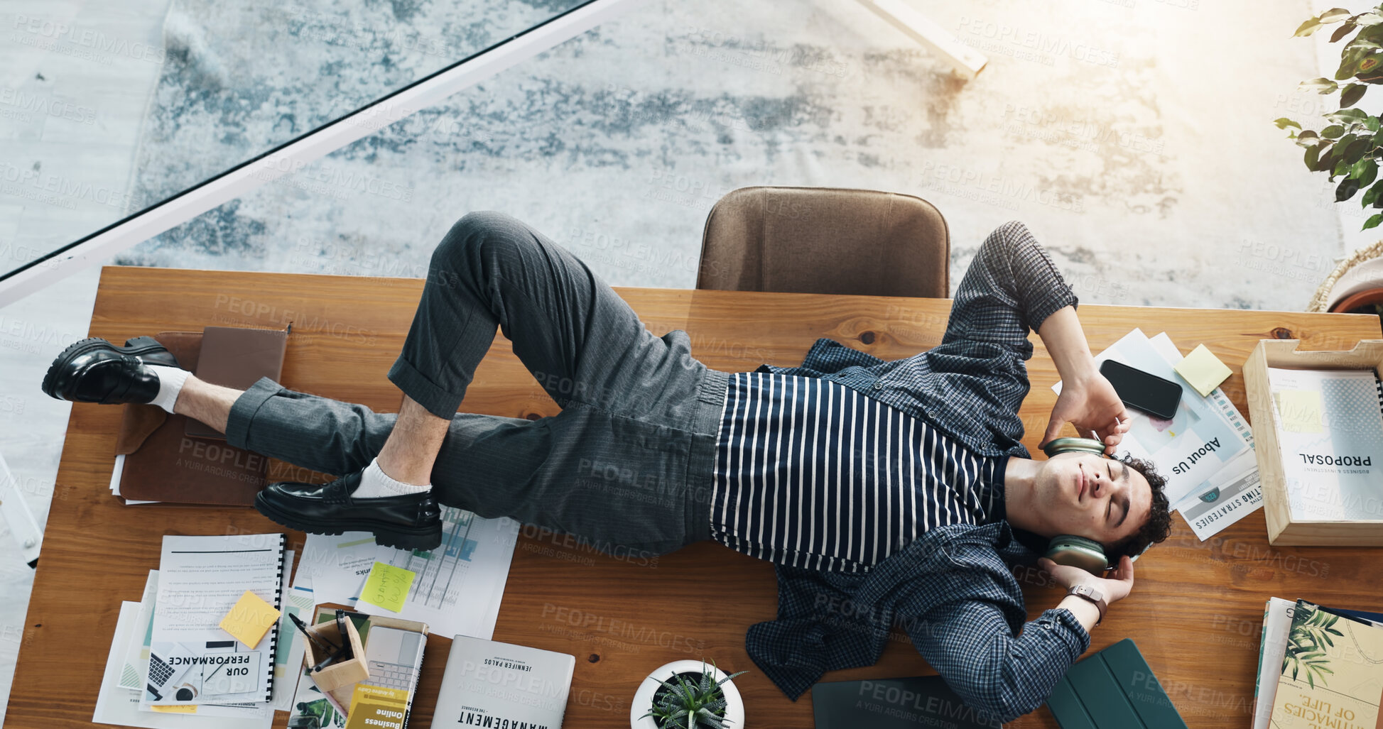 Buy stock photo Headphones, music or businessman on table to relax for break, radio entertainment or audio. Track, above or streaming podcast in office with calm employee lying on desk in workplace for rest or peace