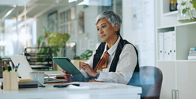 Buy stock photo Creative, mature woman and tablet in office for editor feedback, information and article post. Female journalist, digital and proofreading of latest news, update draft and review story of publication