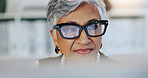 Smile, woman and reading on computer in office for editor feedback, information and article post. Mature journalist, glasses and reflection of pc for proofreading, update draft and story publication