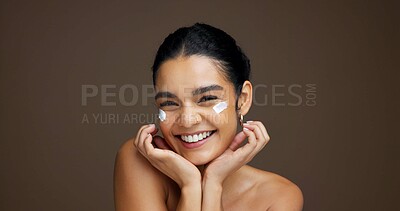 Buy stock photo Beauty, portrait and girl with face cream in studio for collagen treatment, hydration and self care. Mockup, woman and happy with cosmetics product on brown background for skin glow and anti ageing