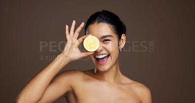 Buy stock photo Happy woman, portrait or lemon with skincare for vitamin C or detox on a brown studio background. Face, female person or model with smile or natural organic fruit for citrus acid, health and collagen