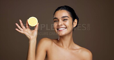 Buy stock photo Happy woman, portrait or lemon with vitamin C for detox or skincare on a brown studio background. Face, female person or model with smile or natural organic fruit for citrus acid, health and collagen