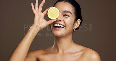 Buy stock photo Happy woman, portrait or lemon with vitamin C in studio for skincare detox on a brown background. Face, female person or model with smile or natural organic fruit for citrus acid, health and collagen