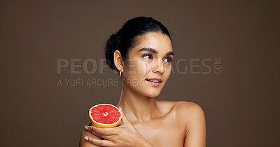 Buy stock photo Skincare, beauty and woman with grapefruit, smile and happy for treatment, self care or smooth skin. Studio background, thinking and person with vitamin C for hydration, mockup space and dermatology