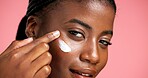 Portrait, hydration and black woman with cream, skincare and smile for healthy skin and dermatology. Happy, person and cosmetics for facial treatment, studio background and lotion for beauty or shine
