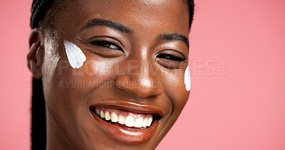 Buy stock photo Portrait, black woman and happy with cream in studio for beauty, facial hydration and treatment. Smile, female person and collagen lotion of self care, sunscreen benefits and shine on pink background