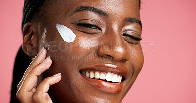 Buy stock photo Face cream, happy and black woman in portrait for sunscreen, beauty and facial treatment. Glow, apply and African person in studio with moisturizer, lotion and smile for skincare on pink background