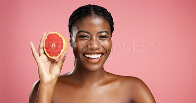 Buy stock photo Portrait, black woman and grapefruit for skincare in studio for vitamin c, brighten skin and natural detox. Female person, fruit and organic benefits, beauty and dermatology shine on pink background