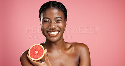 Buy stock photo Portrait, black woman and grapefruit for beauty in studio for vitamin C, brighten skin and natural detox. Female person, fruit and organic benefits, skincare and dermatology shine on pink background