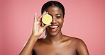 Portrait, black woman and lemon for beauty in studio for vitamin c, brighten skin and natural detox. Female person, citrus fruit and organic benefits, skincare and exfoliate shine on pink background
