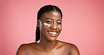Portrait, black woman and smile with lotion in studio for beauty, facial hydration and treatment. Happy, female person and collagen cream of self care, sunscreen benefits and shine on pink background