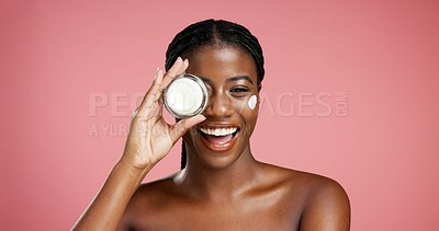 Buy stock photo Portrait, black woman and smile with cream in studio for beauty, facial hydration and treatment. Happy, female person and lotion product for self care, sunscreen benefits and shine on pink background