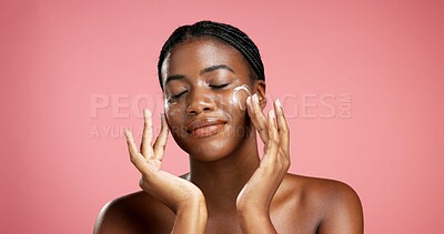 Buy stock photo Black woman, lotion and skincare with face cream in studio for moisturizer on a pink background. Female person, model and applying cosmetics for skin protection, anti aging or sunscreen on space