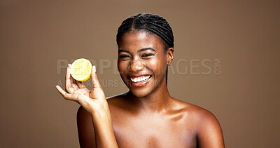 Buy stock photo Skincare, happy and portrait of black woman with lemon in studio for natural, organic or facial glow. Dermatology, beauty and African person with citrus fruit for face brightening by brown background