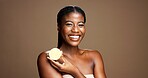Beauty, happy and portrait of black woman with lemon in studio for natural, organic or facial glow. Dermatology, skincare and African person with citrus fruit for face brightening by brown background