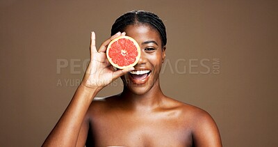 Buy stock photo Happy, black woman and portrait with grapefruit in studio for skincare on a brown background. Space, female person or African model with smile or natural organic fruit for vitamin diet or nutrition