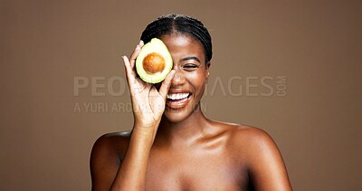 Buy stock photo Skincare, avocado and portrait of black woman in studio with natural, antioxidants or face glow. Happy, beauty and African female person with fruit for moisturizing dermatology by brown background.