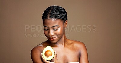 Buy stock photo Happy, woman and skincare with avocado, cosmetics and treatment for bodycare, self care or wellness. Studio background, natural benefits and black person with fruit for healthy skin and mockup space