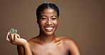 Beauty, face and gua sha with black woman on studio space for dermatology or wellness. Jade stone, smile and skincare with happy African model on banner to massage or relax skin for antiaging routine