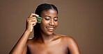 Facial massage, gua sha and skincare with black woman on studio space for dermatology or wellness. Beauty, jade stone and smile with African model on banner to relax skin for antiaging routine