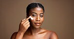 Cream, skincare and portrait of black woman in studio for beauty product, cosmetics and dermatology. Glow, hyaluronic acid and self care with person and lotion on brown background space for retinol