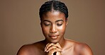 Calm, skincare and black woman in studio for beauty, natural or facial glow with relax. Grooming, cosmetics and peaceful African female person with health, wellness or dermatology by brown background