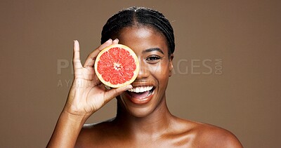 Buy stock photo Happy, black woman or portrait with grapefruit for health or skincare on brown studio background. Face, female person or model with smile or natural organic fruit for vitamin C, beauty or detox