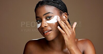Buy stock photo Black woman, portrait and eye mask for skincare in studio, dermatology or reduce puffiness on background. Beauty, skin health or hydration with hyaluronic patches or cosmetic product for dark circles