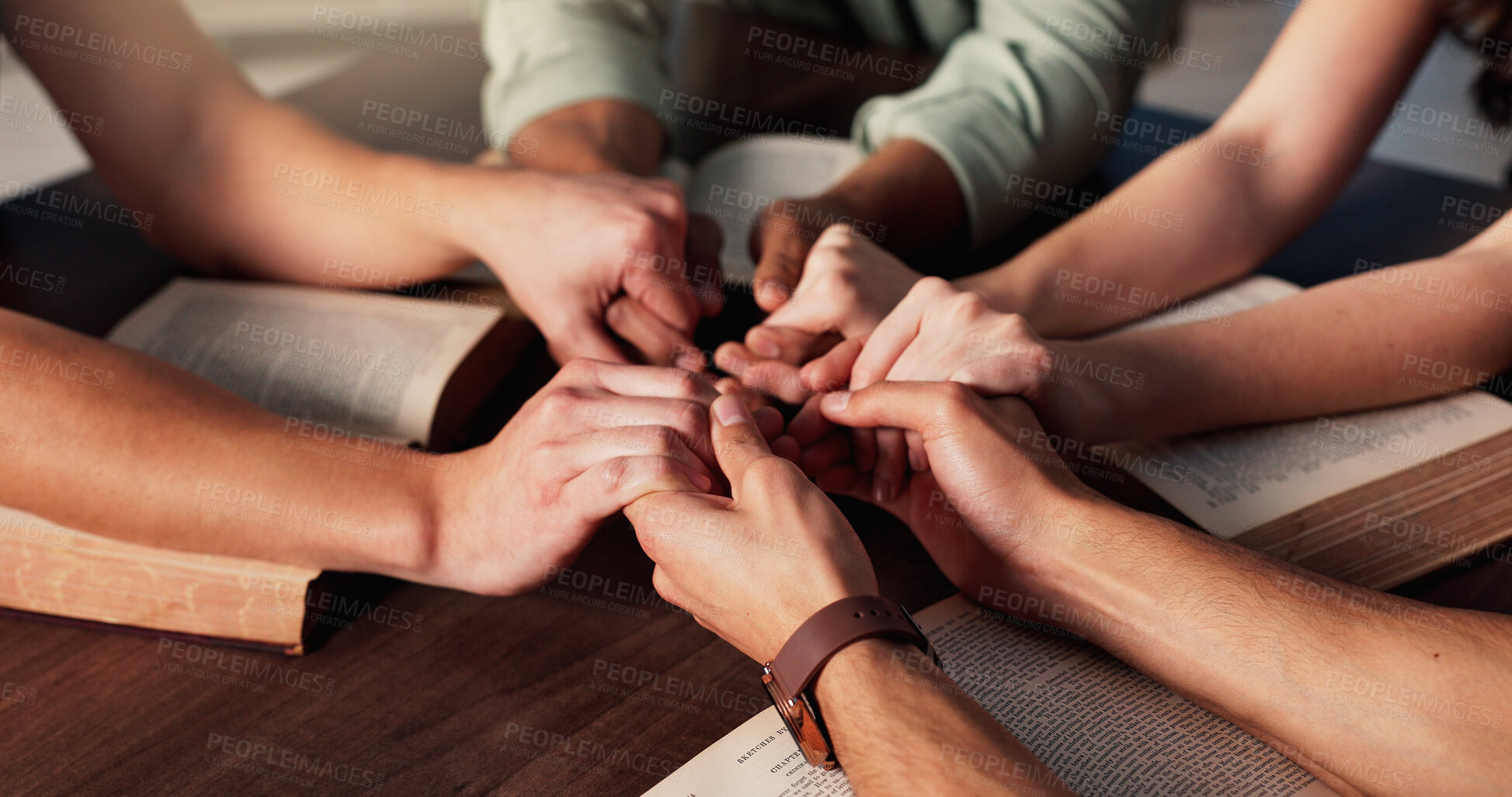 Buy stock photo Bible, holding hands and religion with people in home together for Christian belief, faith or prayer. Book, spirituality and trust with group of friends in apartment for learning or God worship