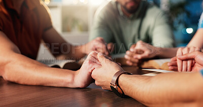 Buy stock photo Bible, holding hands and prayer with people in home together for Christian belief, faith or religion. Book, community and spirituality with group of friends in apartment for learning or God worship