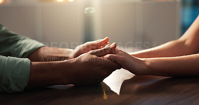 Buy stock photo Holding hands, support or comfort with people by table, help or advice with sympathy. Trust, care and empathy with consoling for challenge, crisis or kindness with compassion in closeup in home