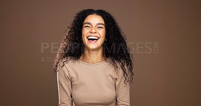 Buy stock photo Natural, laugh and portrait of woman in studio for beauty, curly hairstyle and healthy texture. Hair care, mockup space and person with shine for treatment, growth and cosmetics on brown background