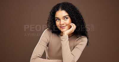 Buy stock photo Thinking, happy and woman with hair care in studio with ideas for natural, beauty or cosmetics. Smile, choice and female person with decision for healthy curly hairstyle for glow by brown background.